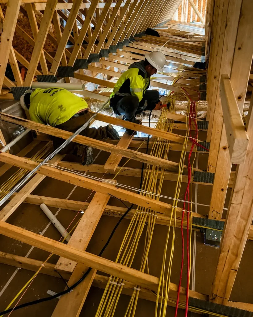 Sentry Electrical team working in a truss bay on a multifamily electrical project in South Dakota